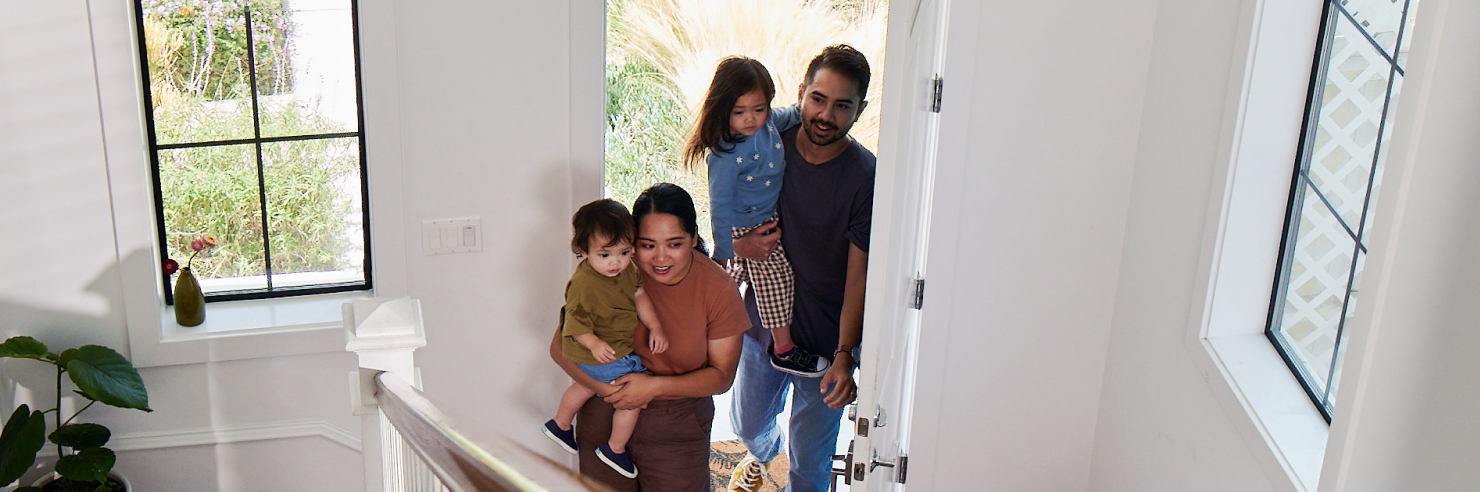 Parents and children entering new home